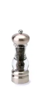 A stainless steel and glass pepper grinder filled with whole peppercorns, standing upright against a white background.