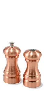 Two copper-colored salt and pepper mills are standing side by side against a white background. The salt mill has a knob on top, while the pepper mill has small holes for dispensing pepper.