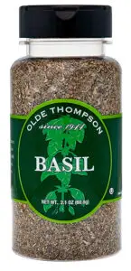 A jar of dried basil by Olde Thompson. The label is green with a basil leaf design and reads since 1944. The jar contains 2.1 oz (60.8g) of basil.