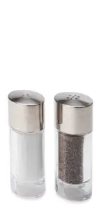 Two glass shakers with silver lids. One contains white salt, and the other holds black pepper. They are positioned side by side against a plain white background.