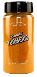 A clear plastic jar of Olde Thompson Ground Turmeric with a black lid, containing 5.3 oz (150.3g) of vibrant orange spice. The label reads Olde Thompson since 1944 above the product name.