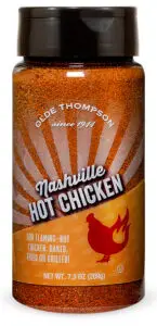 A spice bottle labeled Olde Thompson Nashville Hot Chicken with a fiery chicken icon. The packaging notes it is suitable for baked, fried, or grilled chicken, and the bottle contains 7.3 oz (209g) of spice blend.