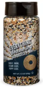 A bottle of Olde Thompson Everything Seasoning, labeled for bagels and more. Includes garlic, onion, sesame seeds, and poppy seeds. The bottle contains 7.5 oz (213g) of seasoning.