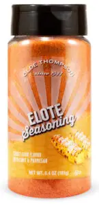 A jar of Olde Thompson Elote Seasoning. The label shows since 1944 and features an image of corn with a chile and parmesan flavor. The net weight is 6.4 oz (181g).