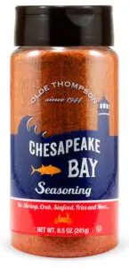 A bottle of Olde Thompson Chesapeake Bay Seasoning, 8.5 oz. The label features a lighthouse, a fish silhouette, and states its for shrimp, crab, seafood, fries, and more.