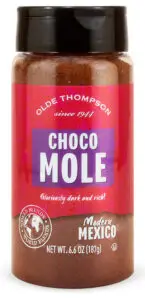 A jar of Olde Thompson Choco Mole seasoning is pictured. The label is purple with white text, stating Gloriously dark and rich! The jar is 6.6 oz (187g).