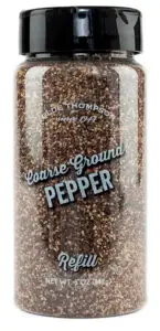 A transparent plastic jar with a black lid, labeled Coarse Ground Pepper Refill. The jar contains dark coarse ground pepper. The label also includes R.E. Thompson and Net Wt: 5 oz (142g).