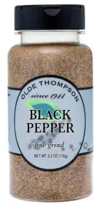 A clear plastic jar of Olde Thompson Black Pepper, fine grind. The label is light gray with black text and a small green chili illustration. Net weight is 6.2 oz (176g).