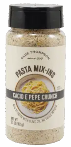 A bottle of Olde Thompson Pasta Mix-Ins labeled Cacio e Pepe Crunch with an image of spaghetti on the front. The label notes it is a seasoning to add to pasta with olive oil, with a net weight of 5.7 oz (162 g).