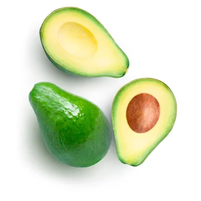 Whole avocado with one half showing the seed and the other half showing the smooth, seedless interior. All pieces are arranged on a white background.